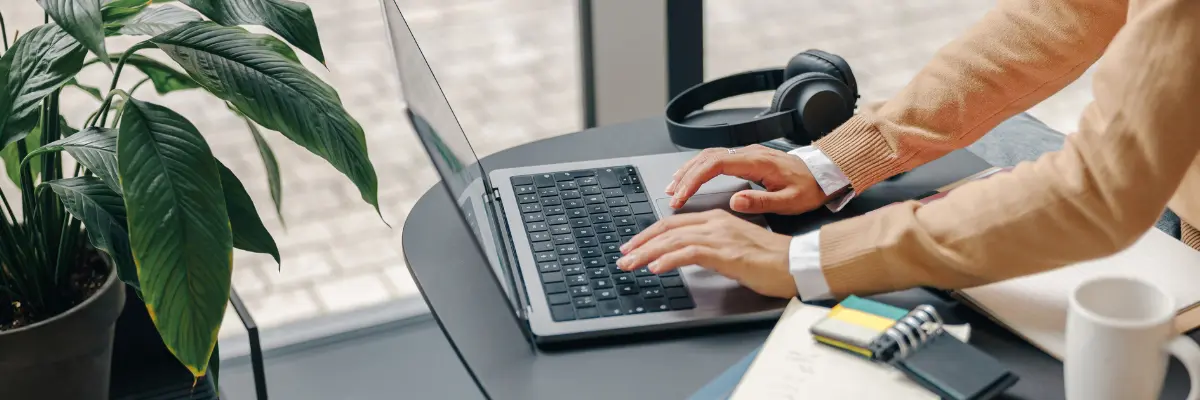 Corretor de imóveis utilizando exemplos criativos de anúncio de imóveis em seu computador.